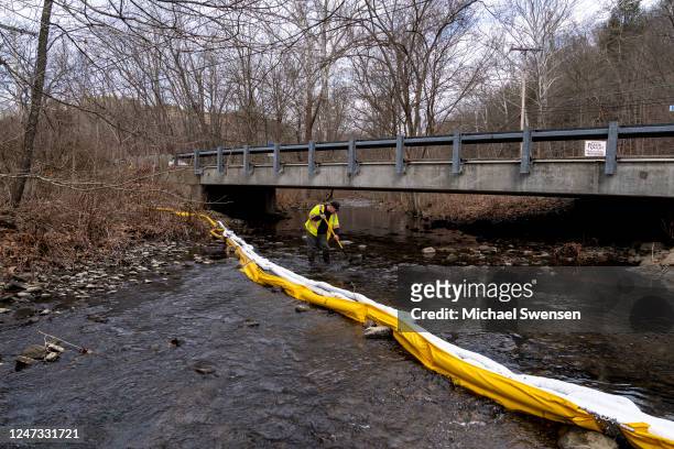 Ron Fodo, Ohio EPA Emergency Response, looks for signs of fish and also agitates the water in Leslie Run creek to check for chemicals that have...