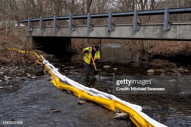 Ron Fodo, Ohio EPA Emergency Response, looks for signs of fish and also agitates the water in Leslie Run creek to check for chemicals that have...