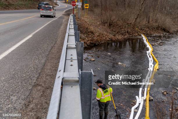 Ron Fodo, Ohio EPA Emergency Response, looks for signs of fish and also agitates the water in Leslie Run creek to check for chemicals that have...