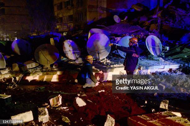 Staff of the Turkey's Disaster and Emergency Management Presidency search through the rubble of a damaged building after a 6.4-magnitude quake hit...