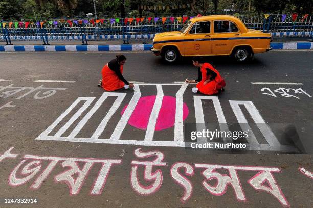 People are seen writing various messages on road in Bengali to commemorate International mother language day in Kolkata , India , on 20 February 2023...