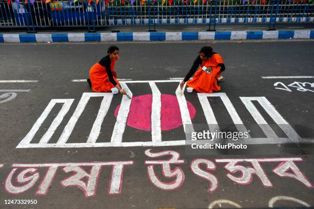 People are seen writing various messages on road in Bengali to commemorate International mother language day in Kolkata , India , on 20 February 2023...