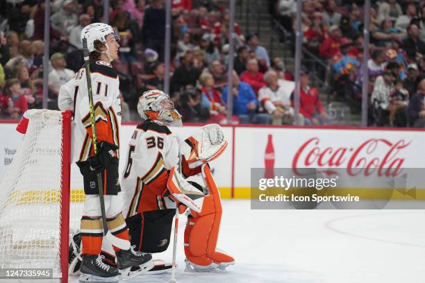 Anaheim Ducks goaltender John Gibson and Anaheim Ducks center Trevor Zegras watch a replay showing goalie interference during the game between the...