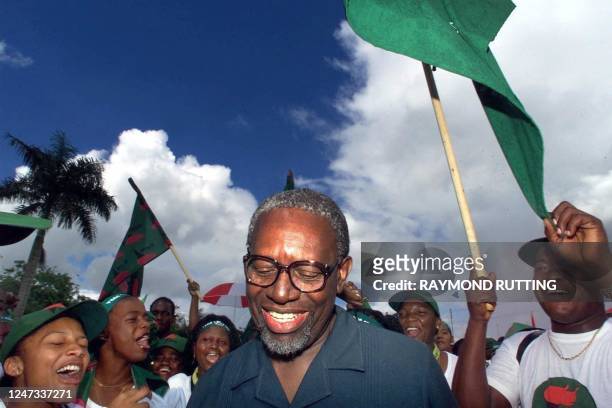 Former Surinamese President Ronald Venetiaan of the New Front party coalition is welcomed by supporters 25 May 2000, as he arrives at Resort...