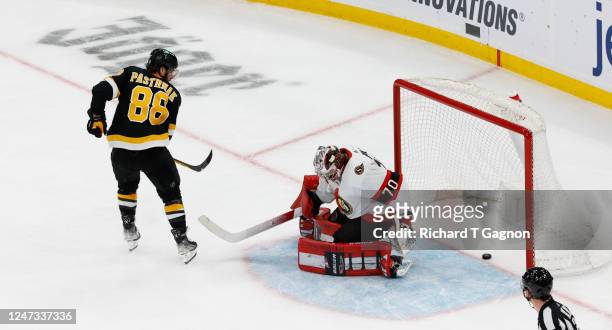 David Pastrnak of the Boston Bruins scores his second goal of the game against Kevin Mandolese of the Ottawa Senators during the third period at the...