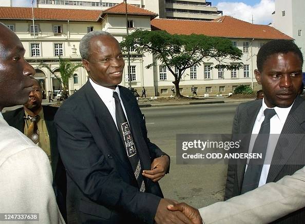 Leader of the Zimbabwean war veterans Chenjerai Hunzvi is greeted by