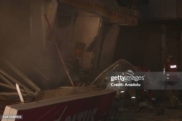 Personnel conduct search and rescue operations on the workplace damaged in previous earthquakes in Antakya district of Hatay following 6.4 and 5.8...
