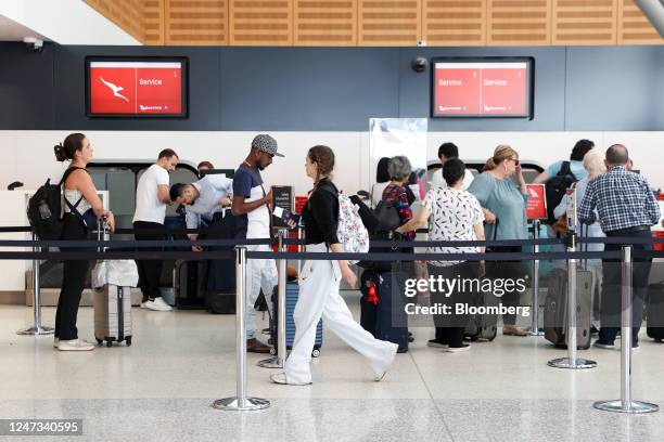 Travelers queue at Qantas Airways Ltd. Check-in counters at Sydney Airport in Sydney, Australia, on Monday, Feb. 20, 2023. Qantas is scheduled to...