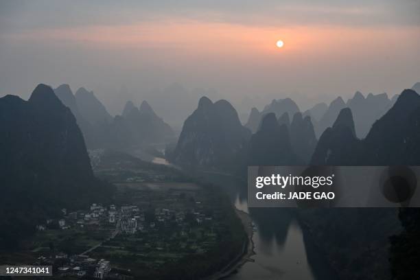 View of Li River and mountains from a scenic tourist spot on Xianggong Mountain during the sunrise in Yangshuo city, in southern China's Guangxi...