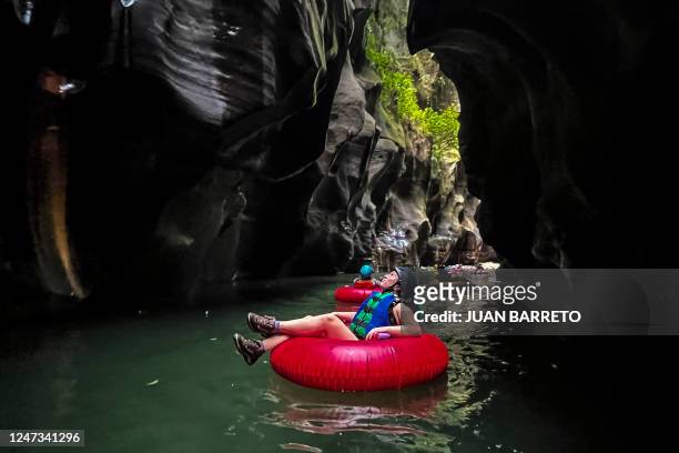 Tourists ride inflatables to cross the Guape canyon in La Uribe municipality in the Meta Department, Colombia, on February 19, 2022. - The Guape...