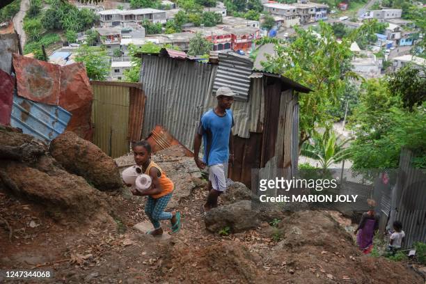 Local residents walks in the "Talus 2" shanty town on the Majicavo slope, near Koungou, on the French Indian Ocean territory of Mayotte, on February...