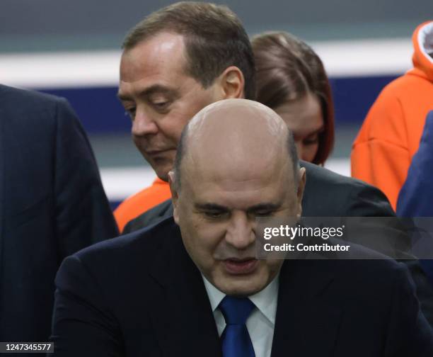 Russian Prime Minister Mikhail Mishustin smiles as First Deputy Chairman of the Council of Security Dmitry Medvedev looks on during Vladimir Putin's...