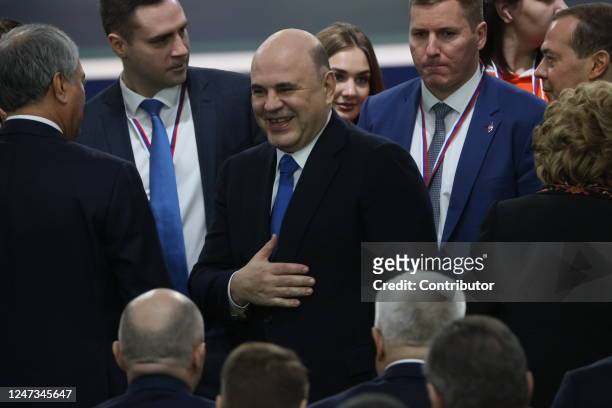 Russian Prime Minister Mikhail Mishustin smiles as First Deputy Chairman of the Council of Security Dmitry Medvedev looks on during Vladimir Putin's...