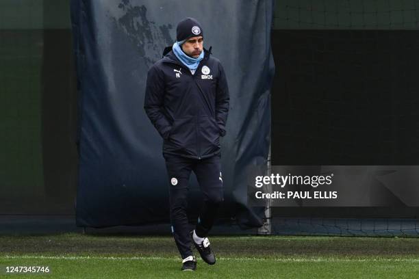 Manchester City's Spanish manager Pep Guardiola reacts as he arrives to attend a team training session at Manchester City training ground in...