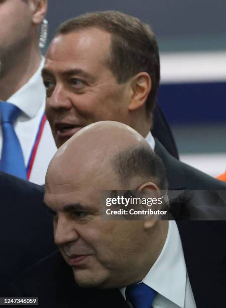 Russian Prime Minister Mikhail Mishustin smiles as First Deputy Chairman of the Council of Security Dmitry Medvedev looks on during Vladimir Putin's...