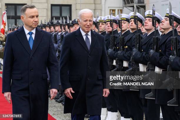 Poland's President Andrzej Duda and US President Joe Biden inspect an honour guard during an arrival ceremony at the Presidential Palace in Warsaw on...