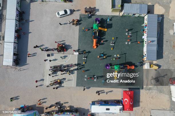 An aerial view of children spending their time at playground at tent city in Gaziantep, Turkiye on February 21, 2023. Volunteers aim to reduce the...