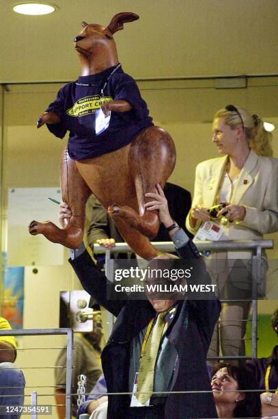 Australian Prime Minister John Howard holds up a giant inflatable kangaroo after the Australian team won the gold medal in the women's field hockey...