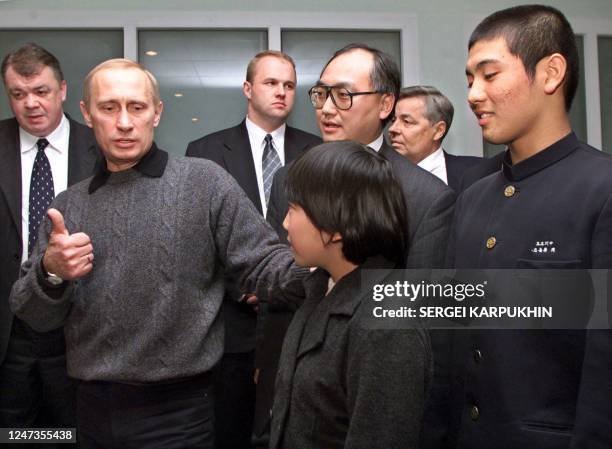 Russian President Vladimir Putin speaks with his Japanese guests Shu Shikiya and Natsumi Gomi , whom he met during his visit to Japan, as they attend...