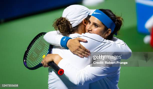 Sania Mirza of India hugs partner Madison Keys of the United States after finishing her last-ever career match on Day 3 of the Dubai Duty Free Tennis...