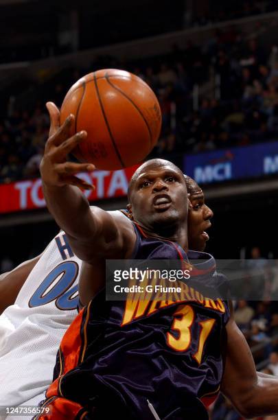Adonal Foyle of the Golden State Warriors grabs a rebound against the Washington Wizards on January 10, 2003 at the MCI Center in Washington DC. NOTE...