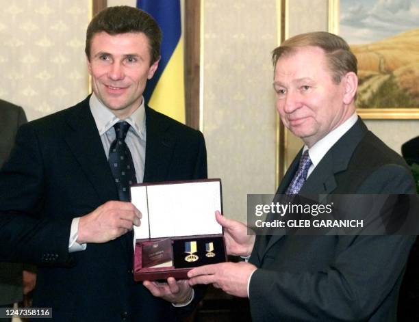 Ukrainian President Leonid Kuchma presents pole vaulter Sergei Bubka with the country's highest medal after announcing that Bubka was granted the...