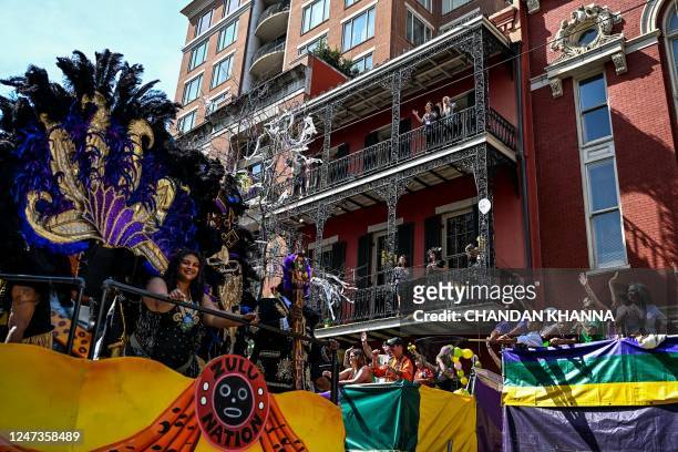 Revellers catch beads from a float in the 2023 Zulu Social Aid and Pleasure Club parade during a Mardi Gras celebration in New Orleans, Louisiana,...