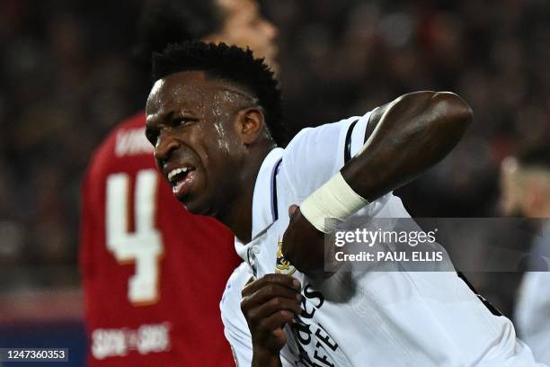 Real Madrid's Brazilian forward Vinicius Junior celebrates scoring the team's first goal during the UEFA Champions League last 16 first leg football...