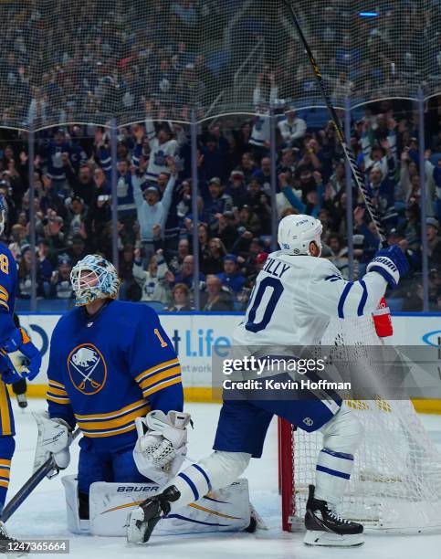 Ryan O'Reilly of the Toronto Maple Leafs celebrates a goal by John Tavares as Ukko-Pekka Luukkonen of the Buffalo Sabres reacts during the first...