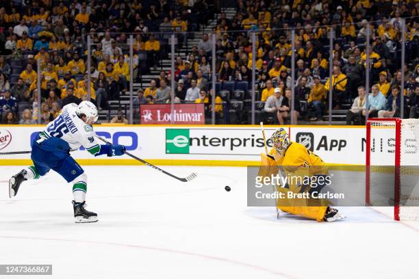 Andrei Kuzmenko of the Vancouver Canucks shoots a goal past Juuse Saros of the Nashville Predators during the second period of the game at...