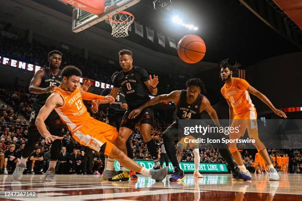 Tennessee Volunteers forward Olivier Nkamhoua , Texas A&M Aggies guard Dexter Dennis , and Texas A&M Aggies forward Julius Marble fight for a loose...