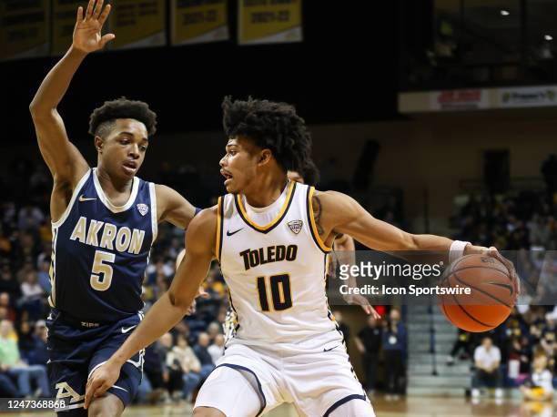 Toledo Rockets guard RayJ Dennis drives to the basket against Akron Zips guard Tavari Johnson during the first half of a Mid-American Conference...