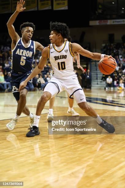 Toledo Rockets guard RayJ Dennis drives to the basket against Akron Zips guard Tavari Johnson during the first half of a Mid-American Conference...