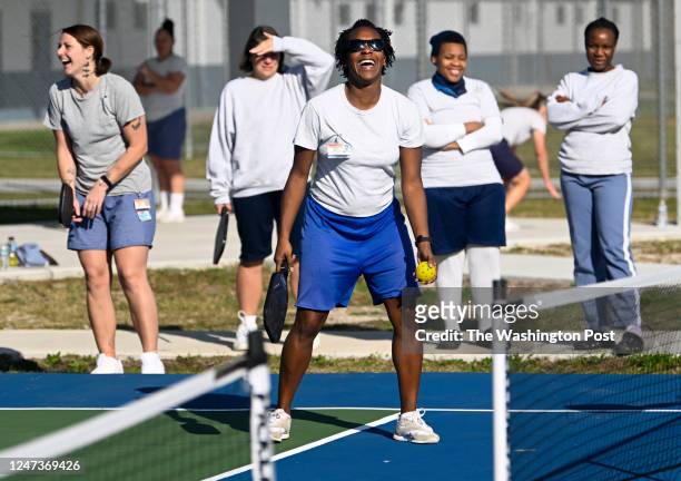 Inmate Kelly Wright breaks out laughing as she plays pickleball under the direction of, Roger BelAir, who teaches inmates how to play at the Lowell...