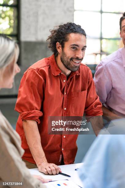 happy businessman ina red shirt in a business meeting - red dress shirt stock pictures, royalty-free photos & images