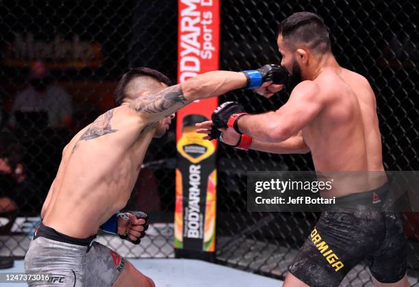 Alex Perez punches Jussier Formiga of Brazil in their flyweight bout during the UFC 250 event at UFC APEX on June 06, 2020 in Las Vegas, Nevada.