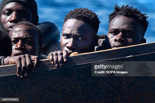 Migrants stare blankly from a precarious metal boat carrying 40-50 migrants across the Mediterranean from Africa. At around 7:30 a.m. On Tuesday, 21...