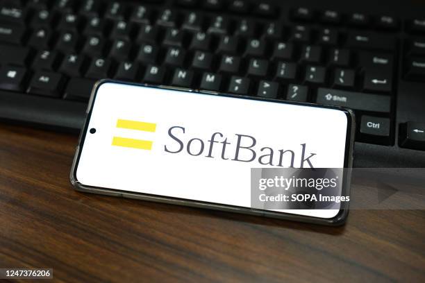 In this photo illustration, a SoftBank Group logo is displayed on the screen of a smartphone.