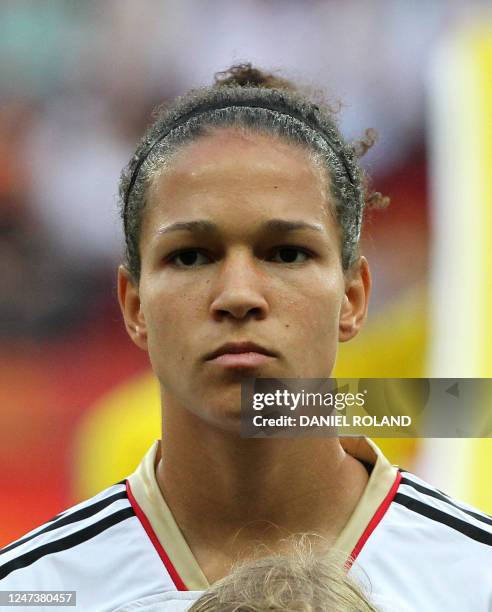 Germany's Celia Okoyino da Mbabi stands for the national anthems before the Group A football match of the FIFA women's football World Cup Germany vs...