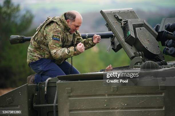 Defence Secretary Ben Wallace speaks to the crew inside an Ajax armoured personnel carrier after a demonstration during a visit to Bovington Camp on...