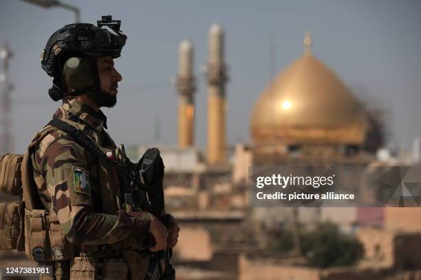 February 2023, Iraq, Samarra: A soldier stands in front of Al-Askari mosque, Resting Place of the Two Imams Ali al-Hadi and Hassan the al-Askari,...