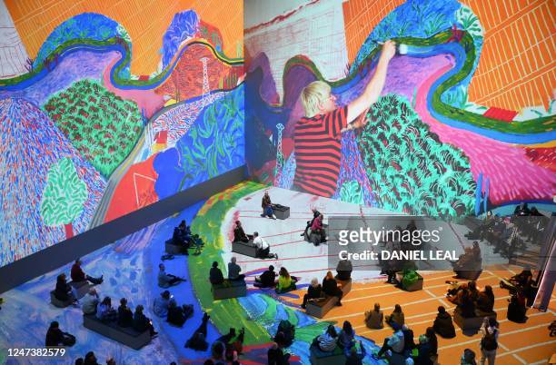 Visitors attend the 'David Hockney: Bigger & Closer immersive exhibition at the Lightroom gallery in London on February 22, 2023. - David Hockney's...