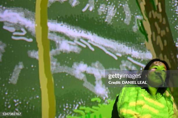 Visitors attend the 'David Hockney: Bigger & Closer immersive exhibition at the Lightroom gallery in London on February 22, 2023. - David Hockney's...