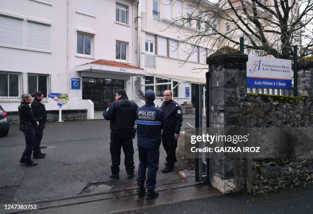 Police officers stand at the entrance of the Saint-Thomas dAquin middle school, where a teacher died after being stabbed by a pupil, in...