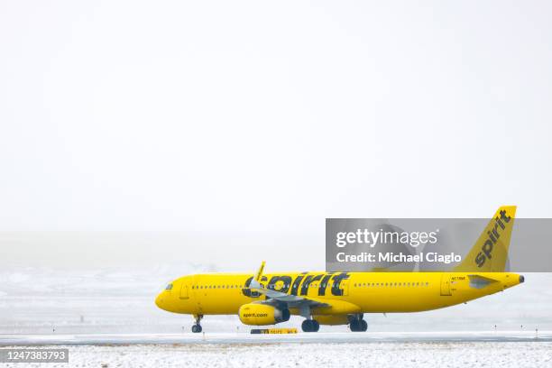 Spirit Airlines airplane taxis toward a runway during a winter storm at Denver International Airport on February 22, 2023 in Denver, Colorado. More...