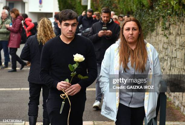 Mourners arrive to lay a flower at Saint-Thomas dAquin middle school, where a teacher died after being stabbed by a pupil, in Saint-Jean-de-Luz,...