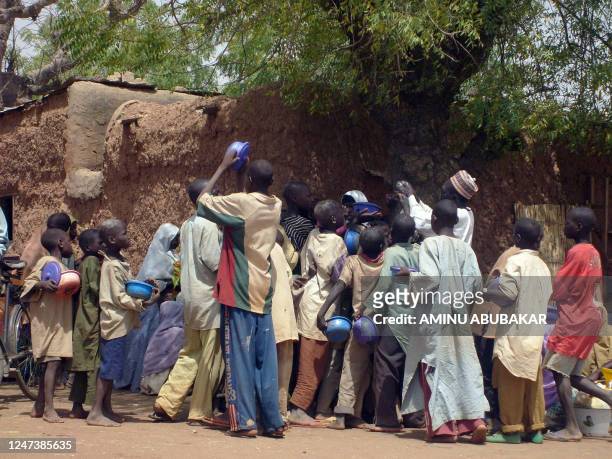 Crowd of child beggars struggle for alms from a man in northern Nigeria's Kano city on March 10,2008. Kano has witnessed a radical upsurge in the...