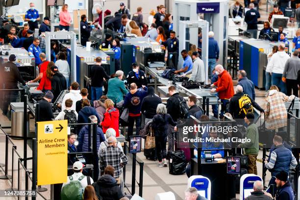 Travelers pass through a TSA security checkpoint during a winter storm at Denver International Airport on February 22, 2023 in Denver, Colorado. More...