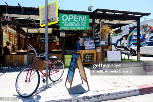 Customers are seen dining on the outdoor patio of Kreation Organic Kafe & Juicery on June 06, 2020 in Venice, California. In an effort to contain the...