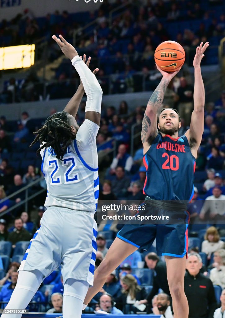 Duquesne forward Joe Reece shoots over Saint Louis University forward ...